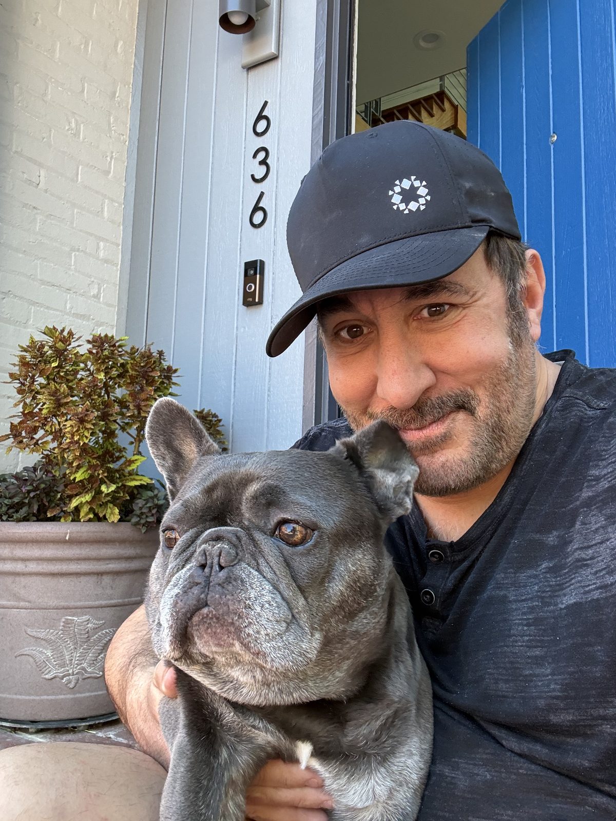 Joe Bernik at home with his French bulldog