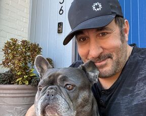 Joe Bernik at home with his French bulldog
